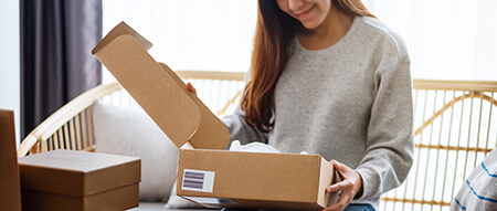 Woman unboxing a product she purchased 